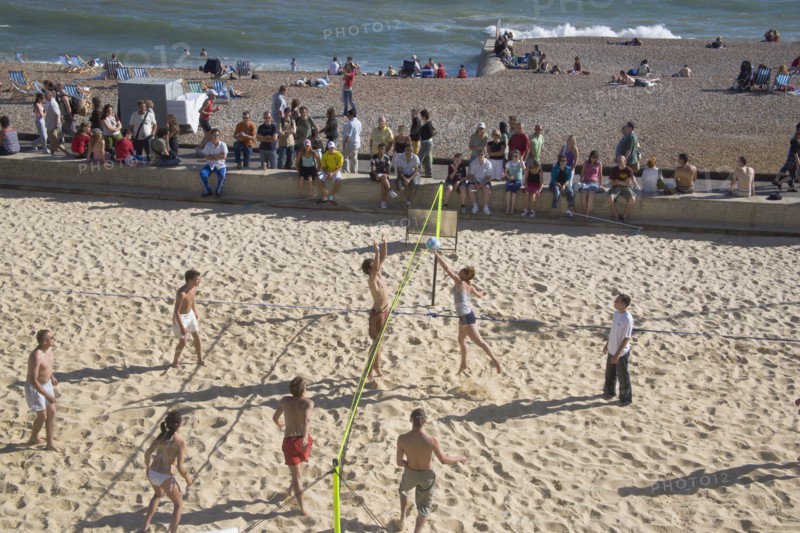 ENGLAND, East Sussex, Brighton, Beach volleyball game on the sands in front of the Grand Hotel.