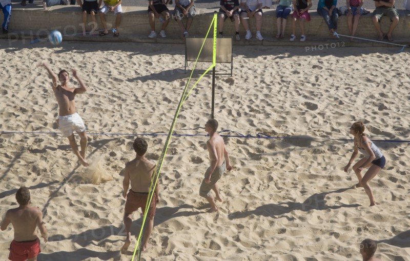 ENGLAND, East Sussex, Brighton, Beach volleyball game on the sands in front of the Grand Hotel.