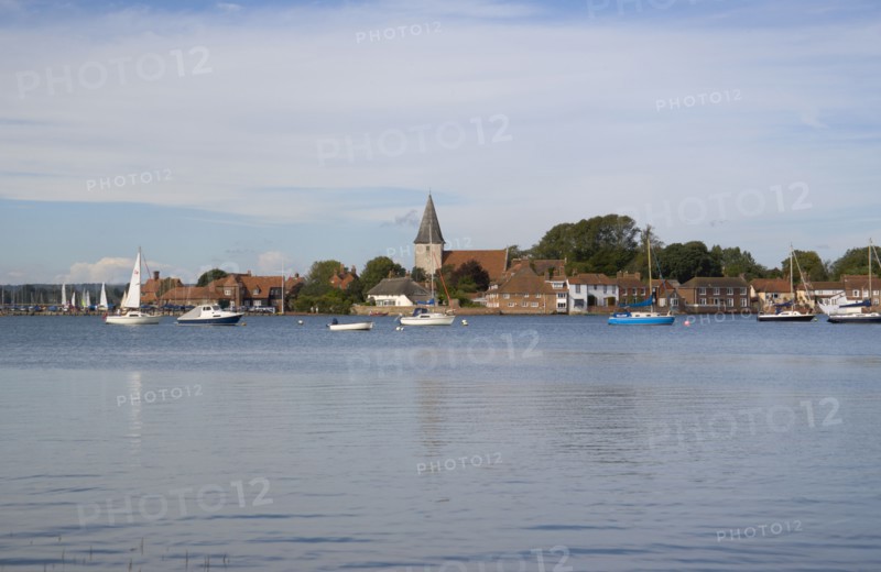 ENGLAND, West Sussex, Bosham, View across water toward Old Bosham with the church spire visible