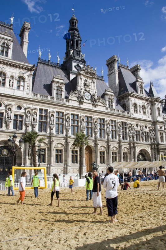 FRANCE, Ile de France, Paris, The Paris Plage urban beach. Young people playing beach football in front of the Hotel de Ville Town Hall