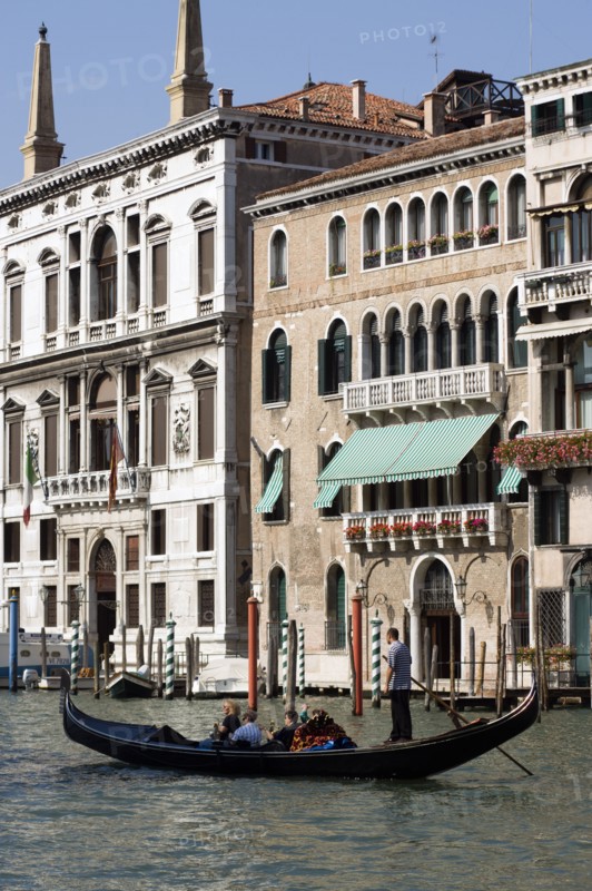 ITALY, Veneto, Venice, A gondola carrying tourists passes the Palazzo Papadopoli (on the left) on the Grand Canal