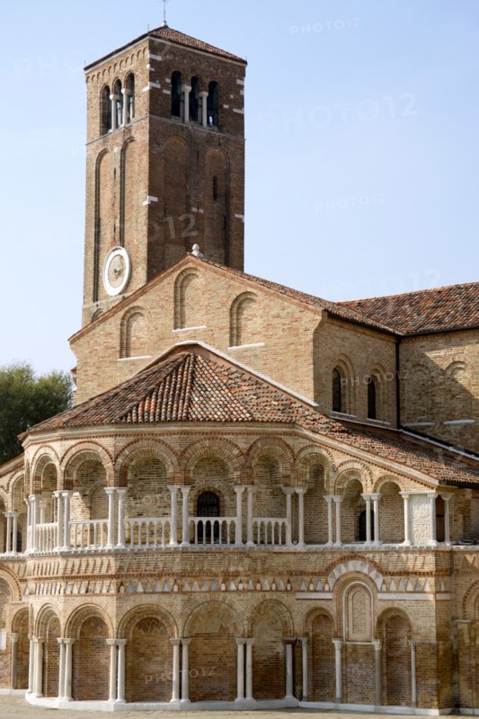 ITALY, Veneto, Venice, The colonnaded exterior of the Basilica dei Santa Maria e Donato on the Canale di San Donato on the lagoon island of Murano