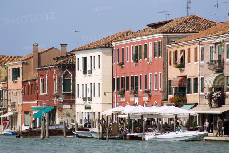 ITALY, Veneto, Venice, Boats on the Canale Grande di Murano moored beside restuarants on the Fondamenta Cavour busy with tourists sightseeing