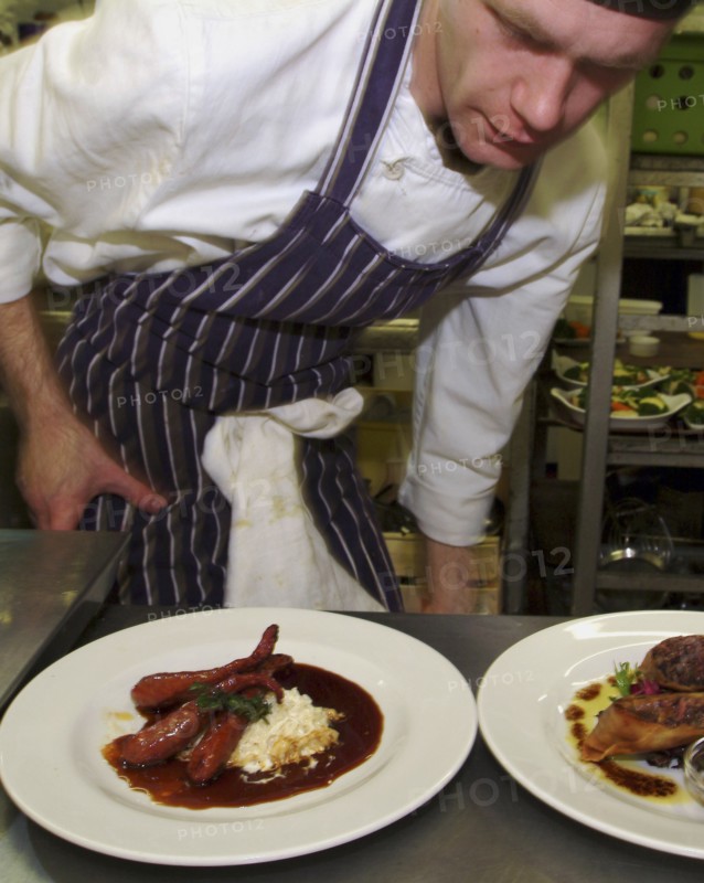 ENGLAND, Bristol, Bristol, Chef checking presentation