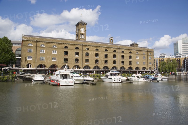 ENGLAND, London, St Catherine’s Dock with yachts moored next to the former warehouses which are now luxury apartments.