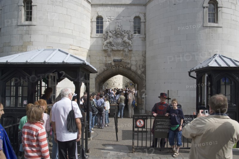 ENGLAND, London, "Tourists entering the Tower of London, yoing boy having his picture teken with a Yoeman Warder or Beefeater."