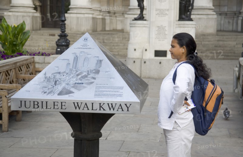 ENGLAND, London, Tourist consulting map outside the Bank of England in  Threadneedle Street.