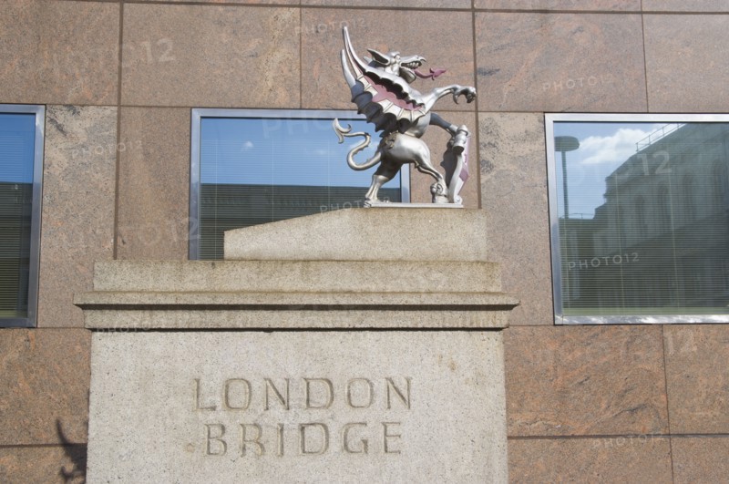 ENGLAND, London, London Bridge detail with statue of Griffin on the Southwark side. Griffins mark the historical city boundary and are where travellers paid their tolls.