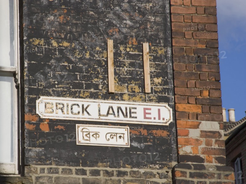 ENGLAND, London, "Whitechapel, Brick Lane bi-lingual street sign in English and Arabic. East End"
