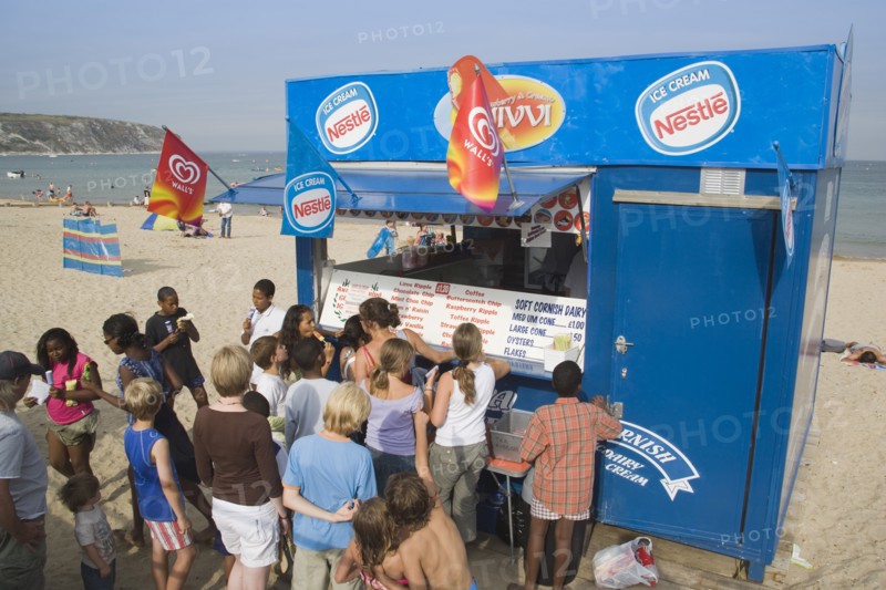 ENGLAND, Dorset, Swanage Bay, A group of children queuing at Ice Cream stall