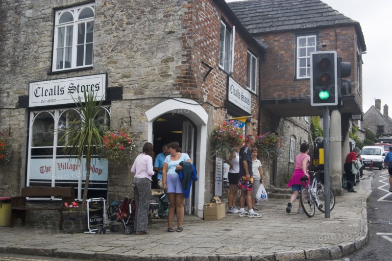 ENGLAND, Dorset, Corfe, People gathered outside a village shop