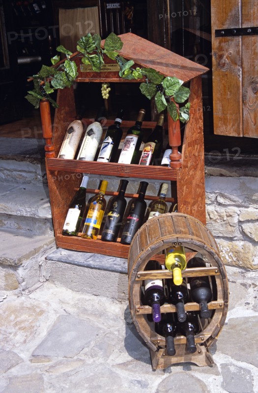 BULGARIA, Veilko Tarnovo, Display of wine bottles outside wine shop.