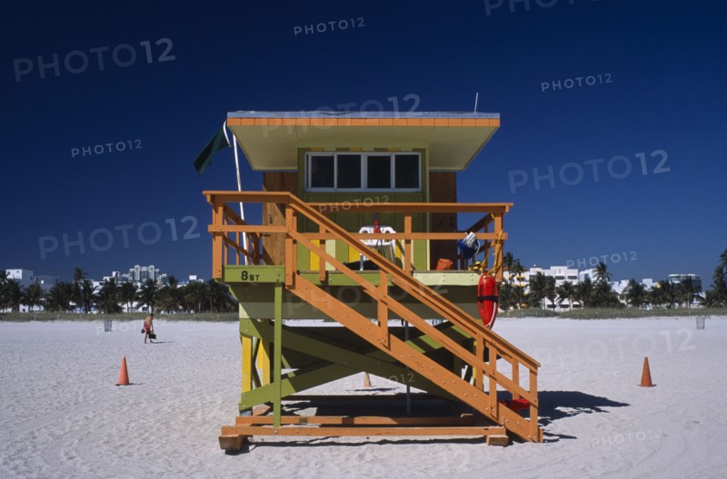 USA, Florida, Miami, South Beach. Ocean Drive. Orange and Green Lifeguard station on sandy beach