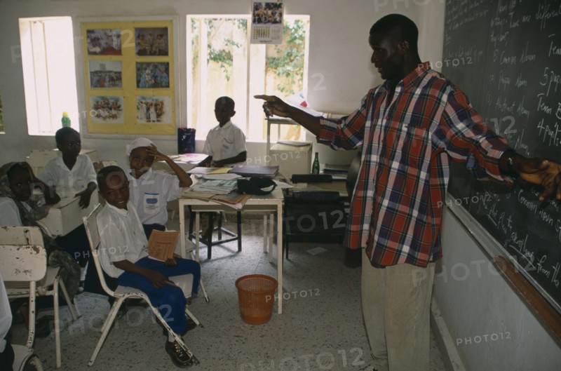 NIGERIA, Kano, Teacher and pupils in classroom of private school.