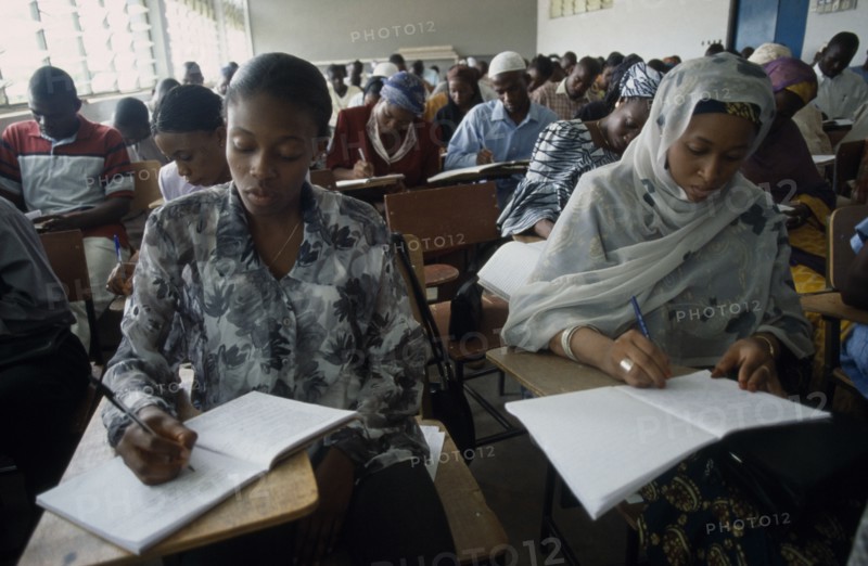 NIGERIA, Kano, Students writing at desks in law school.