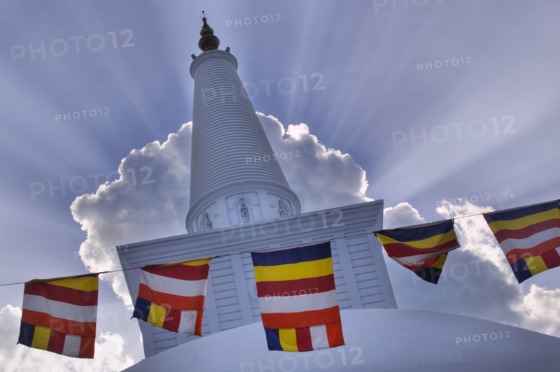 SRI LANKA, Anuradhapura, Prayer flags hanging in front of Ruvanvelisaya Dagoba.