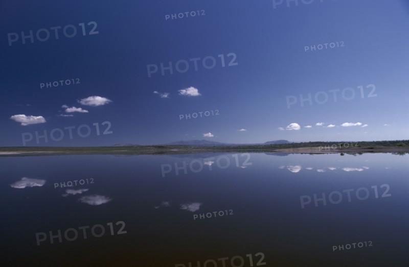 KENYA, Rift Valley, Lake Magadi, Still clouds reflected in Lake Magadi a placid soda lake