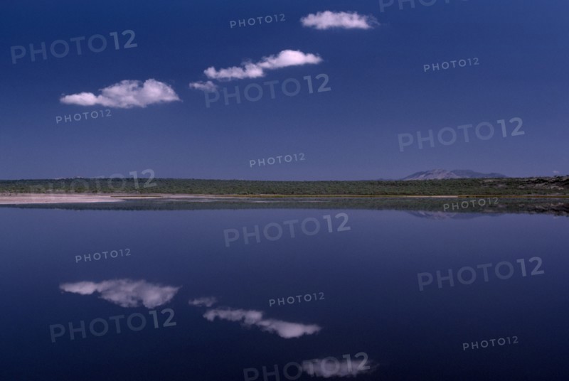 KENYA, Rift Valley, Lake Magadi, Still clouds reflected in Lake Magadi a placid soda lake