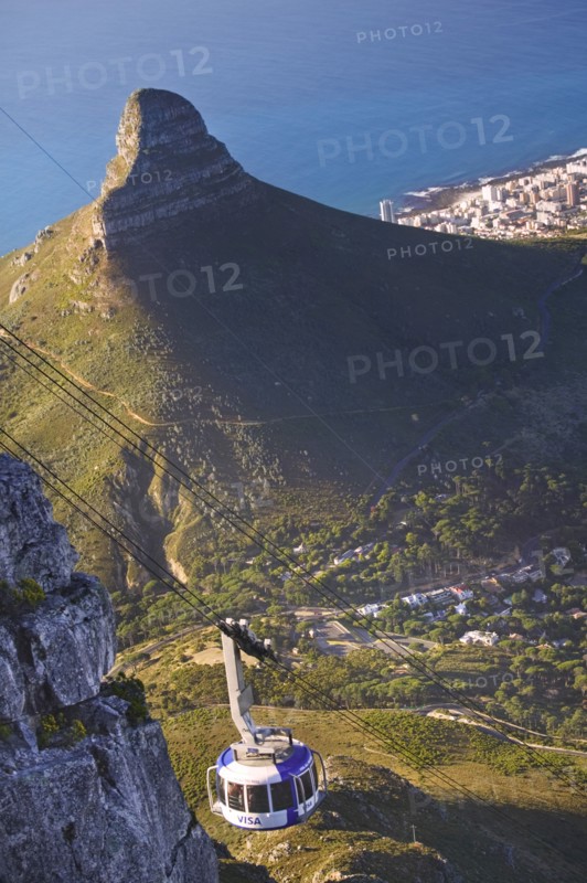 SOUTH AFRICA, Western Cape, Cape Town, Cable car on Table Mountain with the Lion's Head in the background.