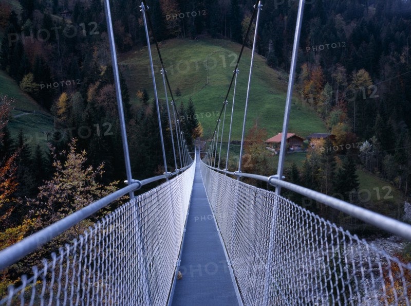 SWITZERLAND, Bernese Oberland, Engstligental , South of Lake Thunersee. Suspension footbridge over River Engstlige which measures 150 metres long stands 30 metres ( 98 feet ) above the river