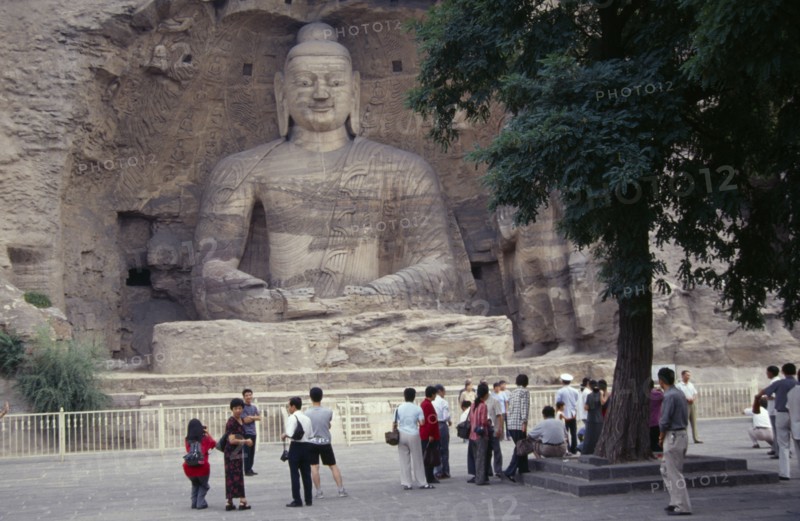 CHINA, Shanxi, Datong, Yungang Caves.  Chinese visitors at ancient Buddhist site with rock carvings dating from AD 386 - 534.