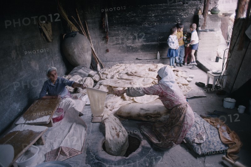 ARMENIA, People, Cooking, Women baking traditional flat bread or lavash also known as Armenian Cracker Bread.