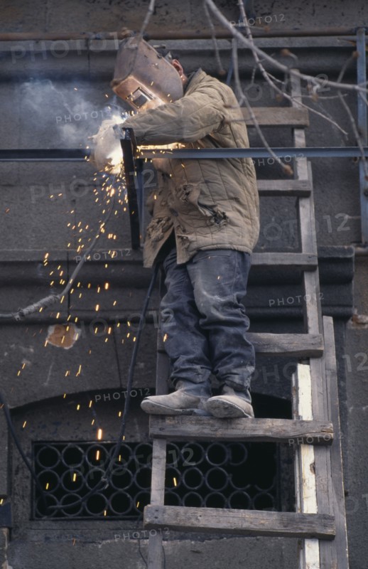 ARMENIA, Yerevan, Welder working on new shop front.