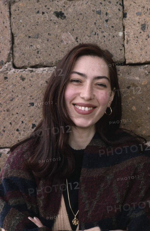 ARMENIA, People, "Head and shoulders portrait of smiling young woman with long, dark hair."