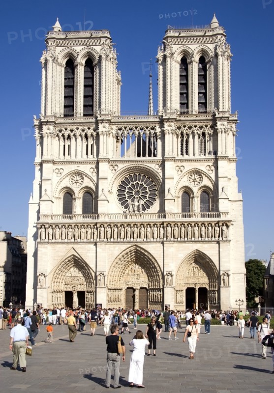 FRANCE, Ile de France, Paris, Tourists in the Place du Parvis Notre Dame in front of the west front of the Gothic Cathedral of Notre Dame on the Ile de la Cite