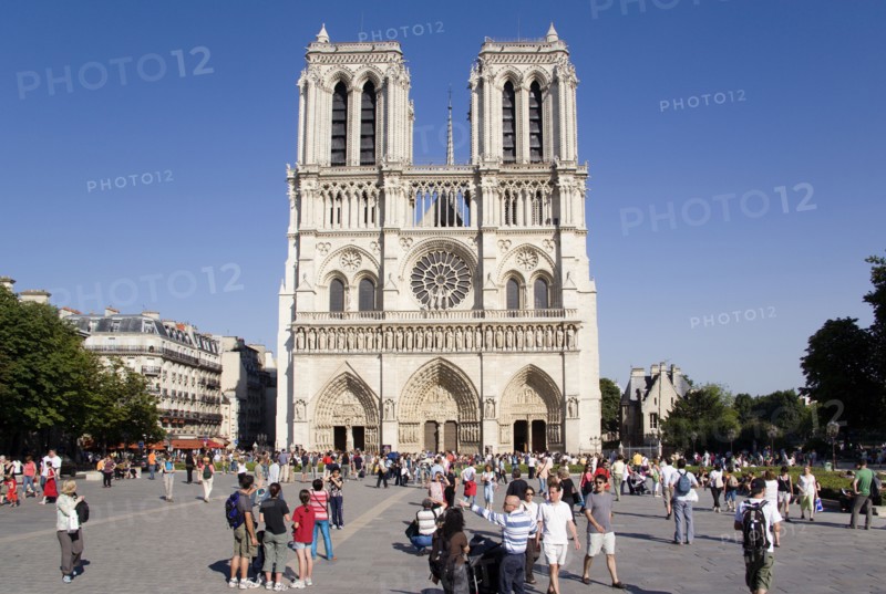 FRANCE, Ile de France, Paris, Tourists in the Place du Parvis Notre Dame in front of the west front of the Gothic Cathedral of Notre Dame on the Ile de la Cite