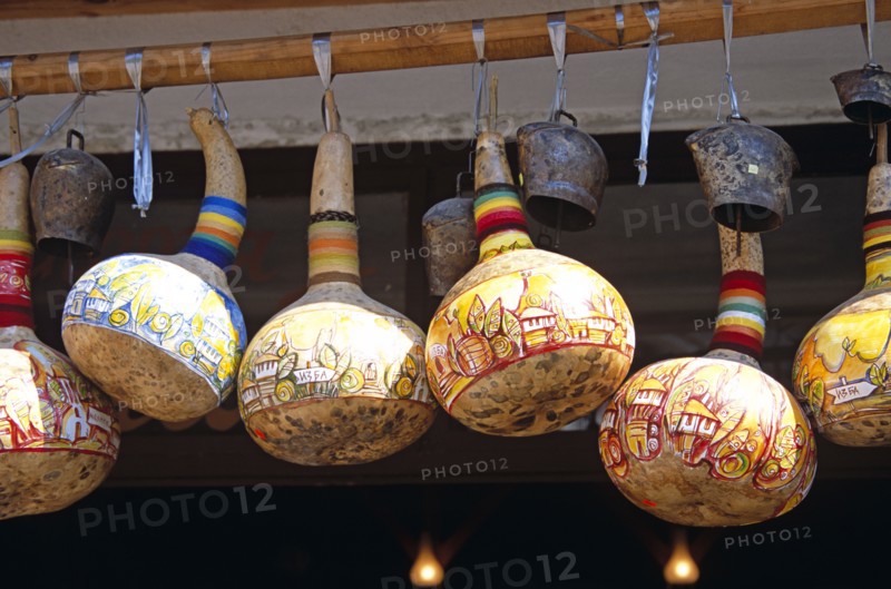 BULGARIA, Melnik., Colourful gourds and cattle bells hanging outside shop.