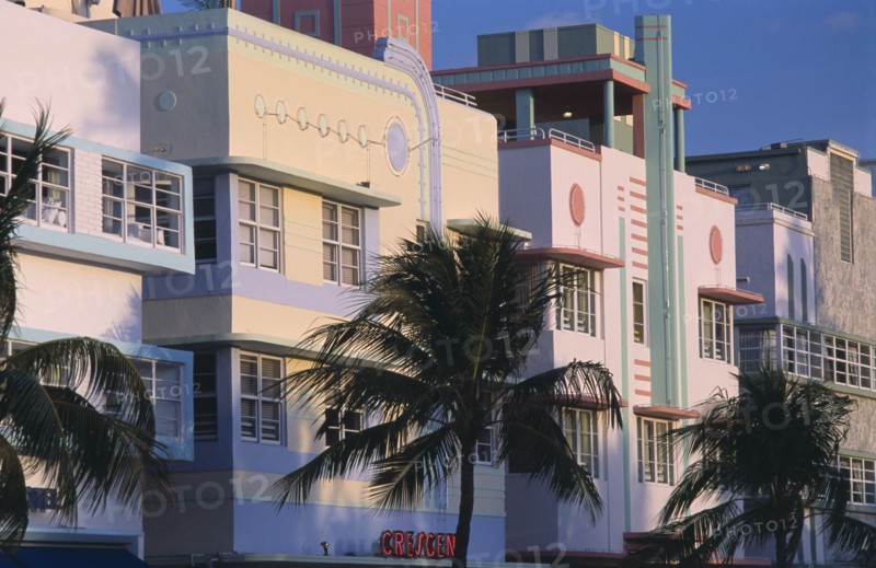 USA, Florida, Miami, South Beach. Ocean Drive. Art Deco hotels and palm trees seen in early morning light