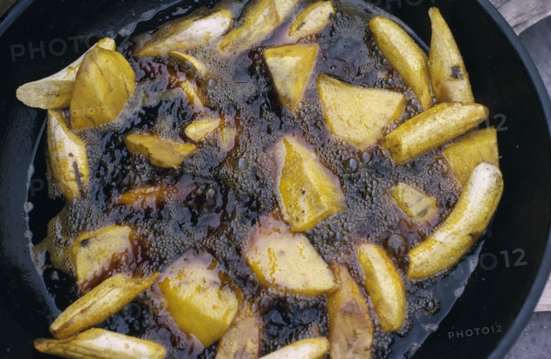 NIGERIA, Food, Cassava and plantain frying in oil.