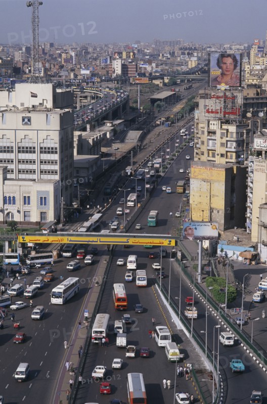 EGYPT, Cairo Area, Cairo, Elevated view over busy city road network with traffic running between tall buildings