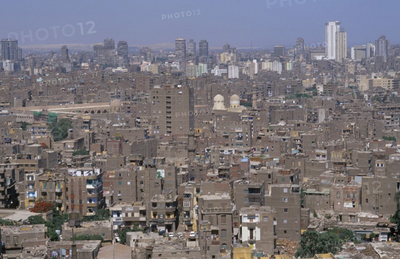 EGYPT, Cairo Area, Cairo, Elevated view over city rooftops with tall buildings on the skyline