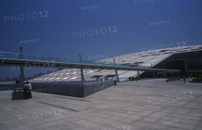 EGYPT, Nile Delta, Alexandria, Bibliotheca Alexandrina modern library exterior with view from complex towards long slender bridge leading to entrance