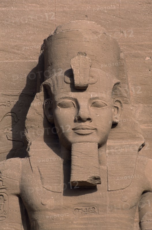 EGYPT, Nile Valley, Abu Simbel, Ramses II colossal enthroned statue. Detail of head and upper torso