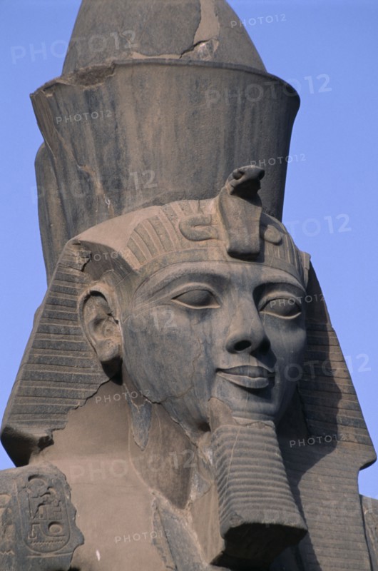 EGYPT, Nile Valley, Luxor, Luxor Temple. Ramses II seated statue with detail of head