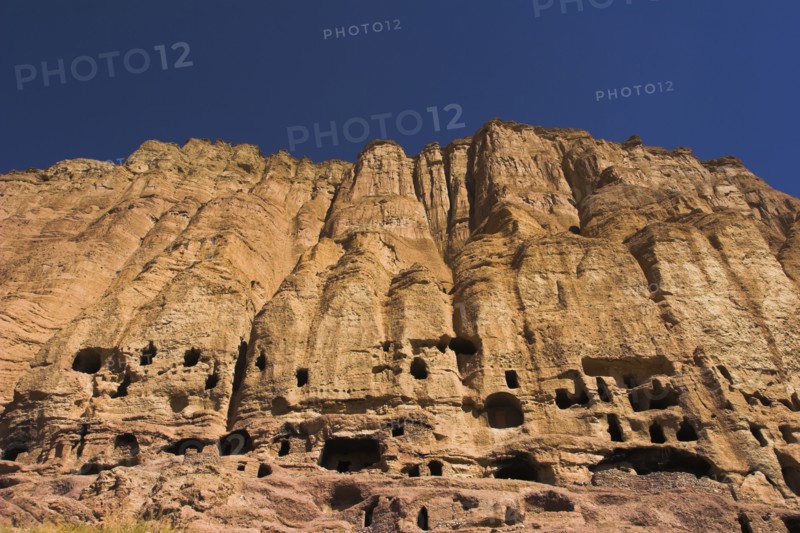 AFGHANISTAN, Bamiyan Province, Bamiyan , Caves in cliffs near empty niche where the famous carved small Budda once stood 180 foot high before being destroyed by the Taliban in 2001