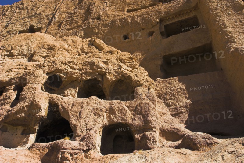 AFGHANISTAN, Bamiyan Province, Bamiyan , Caves in cliffs near empty niche where the famous carved small Budda once stood 180 foot high before being destroyed by the Taliban in 200