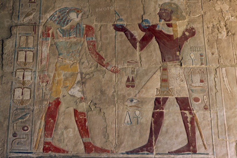 EGYPT, Nile Valley, Thebes, Deir-el-Bahri. Hatshepsut Mortuary Temple. Chapel of Anubis. Relief of Tuthmosis III making offerings to the sun god Ra- Harakhty.