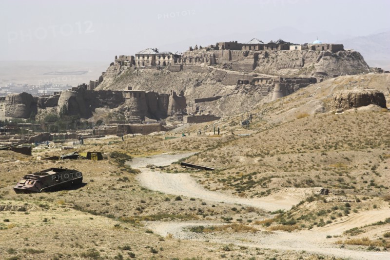 AFGHANISTAN, Ghazni, Military graveyard with ancient city walls and Citadel in background (the Citadel was destroyed during First Anglo Afghan war since rebuilt and still used as a military garrison)