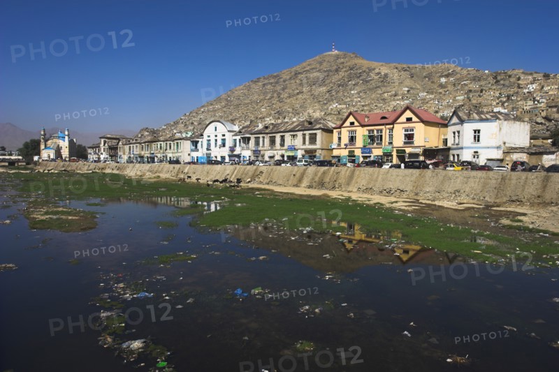 AFGHANISTAN, Kabul, Shah -do-Shamshira Mosque and shops line the banks of the polluted Kabul river
