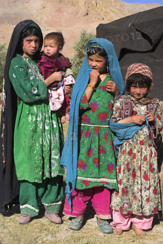 AFGHANISTAN, Ghor Province, Pal-Kotal-i-Guk, "Aimaq nomad camp, Aimaq girls and baby in front of yurt