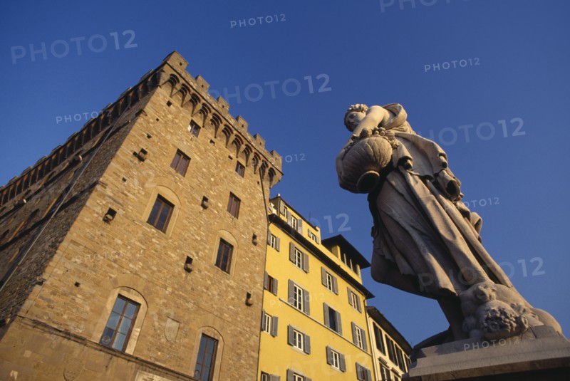 ITALY, Tuscany, Florence, Angled view of building facades and statue by the Ponte Santa Trinita.