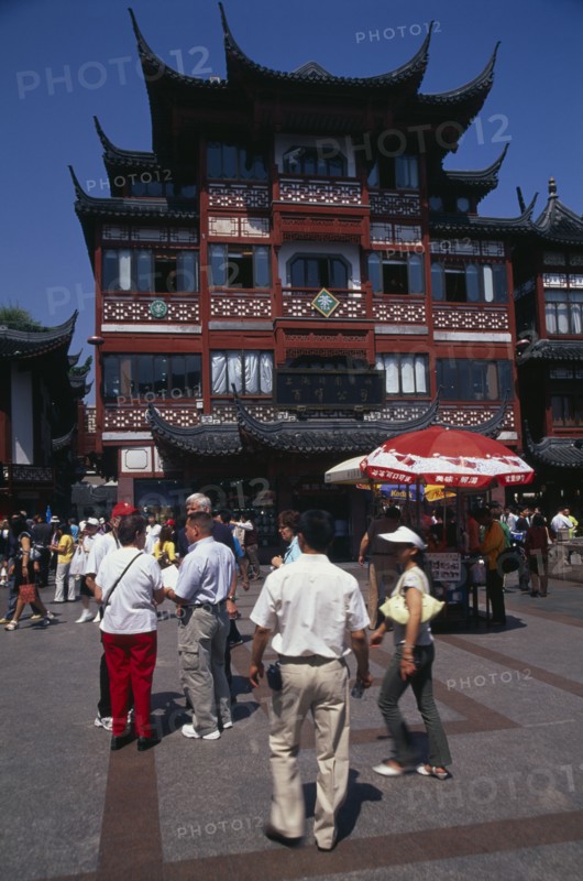 CHINA, Shanghai, "Yu Gardens street scene with shoppers, tourists, shops and souvenir stalls."