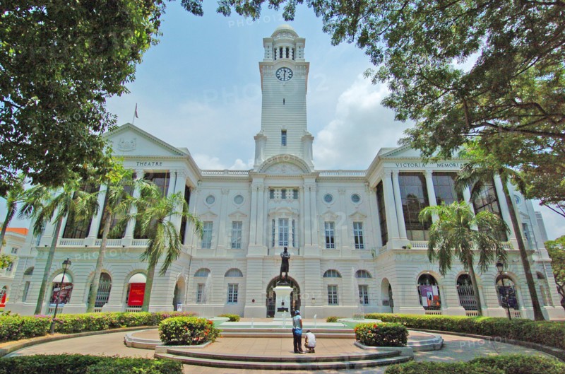 SINGAPORE, PARLIaMENT LANE, "VIEW OF THE VICTORIA THEATRE AND CONCERT Hall. The complex started off with the building of a town hall in 1862. Built during an era of Victorian Revivalism was occurring in Britain, its design reflected this architectural influence with Italianate windows and rusticated columns, and was the first building to reflect this style in Singapore's buildings. In 1901, construction for a neighbouring building began in memory of the late Queen Victoria, with the foundation laid in 1902 and officially opened by the Governor of the Straits Settlements, Sir John Anderson on 18 October 1905 as the Victoria Memorial Hall. The town hall was also heavily renovated and air-conditioned as the Victoria Theatre. In 1979, the memorial hall was renovated again to accommodate the Singapore Symphony Orchestra (SSO), upon which it was renamed as the Victoria Concert Hall. "