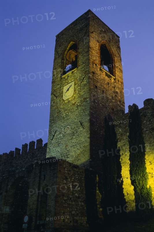 ITALY, Lombardy, Lake Garda , Manerba di Garda.  Castello crenellated walls and bell / clock tower illuminated at night.