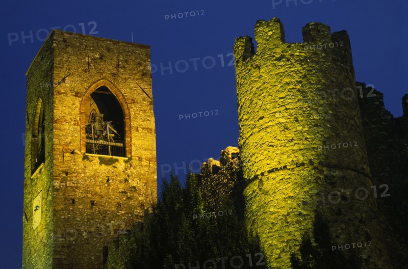 ITALY, Lombardy, Lake Garda , Manerba di Garda.  Castello crenellated walls and bell / clock tower illuminated at night.