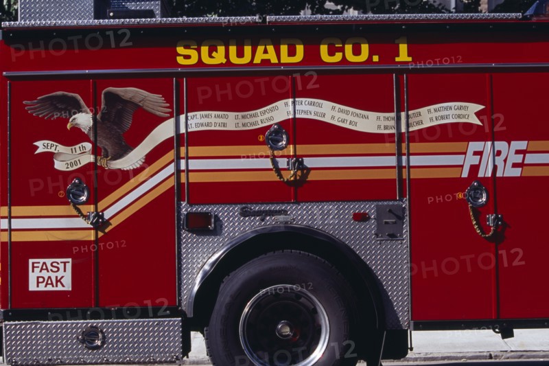 USA, New York, New York City, Part view of fire engine painted with Bald Eagle carrying banner listing some of the New York fire officers killed in the September 11th 2001 World Trade Tower attack.